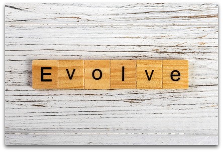 The image for the post you are allowed to evolve as a coach is a white painted background with a woodern grain showing through. Ontop is 6 woodern blocks pushed together, each has a letter on that spells out the word Evolve.
