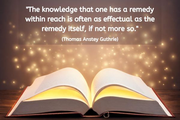 A Book lies open on a table. Whilst the pages it is open at are blank, there is a glow coming from other pages in the book. Surrounding the book are sparkling golden lights - the sort of illustration used to show magic is in the air.
The text above reads: "The knowledge that one has a remedy within reach is often as effectual as the remedy itself, if not more so." (Thomas Anstey Guthrie)