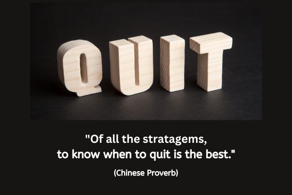 3D letters made in a light coloured natural wood spells out the word QUIT on a black background. The text reads "Of all the stratagems, to know when to quit is the best." (Chinese proverb)