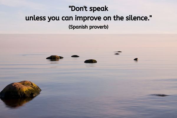 A tranquil image of still water stretching out to the horizon. Occasionally a smooth stone is sticking out above the water line. The text reads: "Don't speak unless you can improve on the silence." (Spanish proverb)