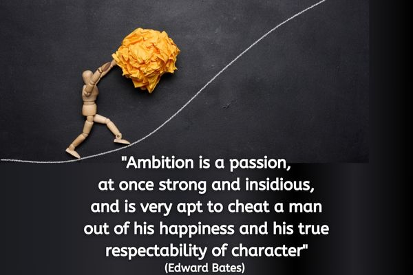 The image portrays a three-dimensional wooden mannequin, similar to those used by artists for drawing reference, pushing a large crumpled ball of yellow paper up a steep hill marked by a white chalk line on a smooth, dark slate background. The wooden mannequin, captured in motion, struggles against the slope, embodying the physical exertion required for its task. Above this scene, the quote "Ambition is a passion, at once strong and insidious, and is very apt to cheat a man out of his happiness and his true respectability of character" by Edward Bates is displayed in white text