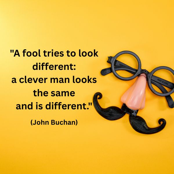 A playful plastic disguise featuring large black glasses, a pink nose, and a curly black moustache sits on a bright yellow background. To the left of the image is the quote: "A fool tries to look different: a clever man looks the same and is different." (John Buchan) The image evokes the contrast between outward appearance and inner authenticity.