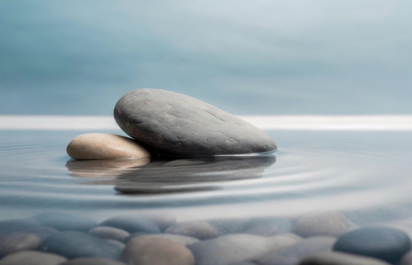 Smooth stones resting in shallow water.